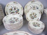 many plates and bowls that are sitting on a table