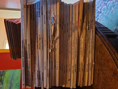 a stack of books sitting on top of a wooden table