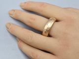 a close up of a person ' s hand with a ring on it