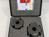 a black case with two tools inside of it on a white surface
