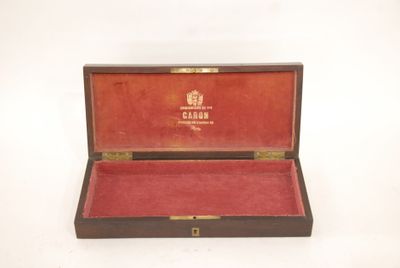 a wooden box with a red velvet lining inside