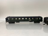 a black train car sitting on a white surface