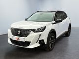 une voiture blanche garée dans une pièce au sol noir