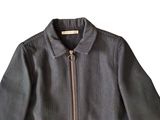 grey jacket with zippers on the front and a zipper down the back