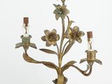 a metal candelab with flowers and candles on it