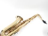 a saxophone that is laying on the ground next to a microphone