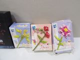 three cards with flowers on them sitting on a table