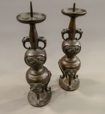 two metal vases that are sitting on a table