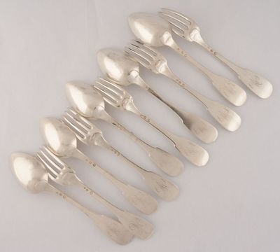 six silver spoons and a fork on a white surface