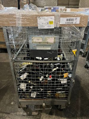 a metal cart with many items in it in a warehouse
