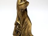 an antique bronze statue of a woman holding a book on a marble base