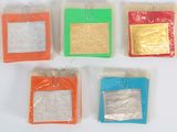 four different colored bags of candy sitting on top of a white surface