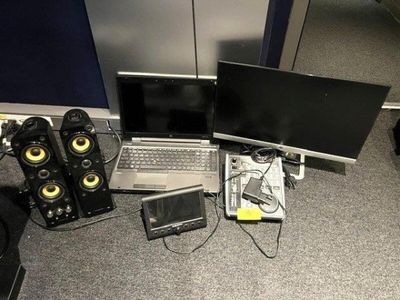 two laptops and speakers on the floor next to each other