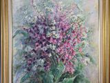 tableau représentant un bouquet de fleurs dans un cadre doré, accroché à un mur bleu