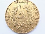 a gold coin on a white surface with a white background