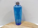 a bottle of blue liquid sitting on a wooden table