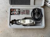 an electric drill in a case on the ground