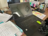 a laptop computer sitting on top of a wooden desk