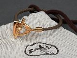 a gold bracelet with a horse head on it