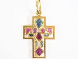 une image représentant une croix en or ornée de pierres multicolores