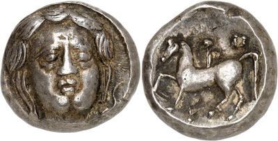 a silver coin with a woman and a horse on it
