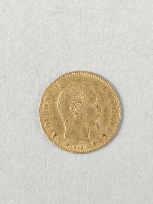 a close up of a gold coin on a white surface