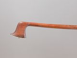an old axe with a wooden handle on a gray background