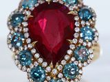 an image of a ring with a ruby and blue stone