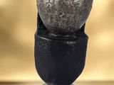 a sculpture of a stack of rocks sitting on a table