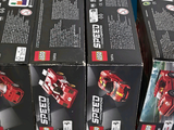 boxes of lego speed cars are stacked on top of each other