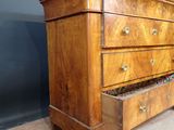 a wooden dresser with a marble top and drawers