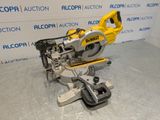a close up of a circular saw on a table in front of a wall