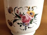 a white cup with a floral design on it