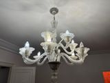 a chandelier that has five lights hanging from it