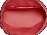 the inside of a red purse with a zipper on it