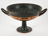 a black and orange vase with a bird on it