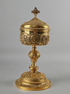 une coupe plaquée or surmontée d'une croix