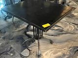 a black table and chairs in a room with marble flooring