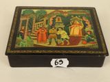 a black box with a painting on it sitting on a table