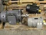 three electric motors sitting on a pallet in a warehouse