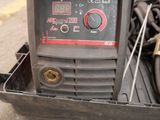 a welding machine that is sitting on the ground