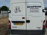 a white van that is parked on the side of the road