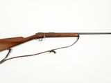 an old rifle with a wooden barrel and a sling on a white background