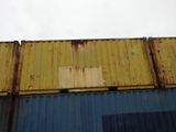 a yellow and blue container sitting on the side of a building