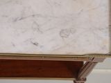 a marble top table with a drawer underneath it