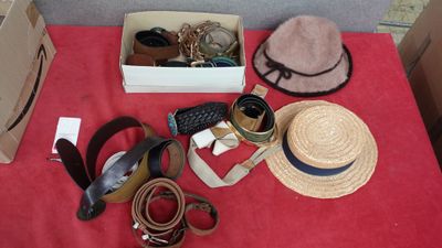 a red table with a hat, hat, belt, and other items on it