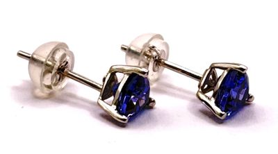 a pair of blue sapphire earrings on a white background