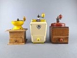 three different types of coffee grinders and a coffee grinder