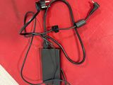 a black charger and a black cord on a red surface