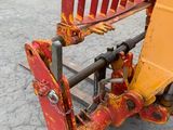 a close up of a red and yellow construction vehicle